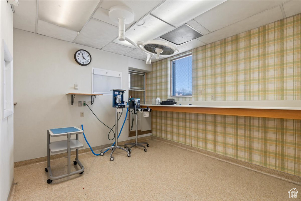 Miscellaneous room featuring wallpapered walls and a paneled ceiling
