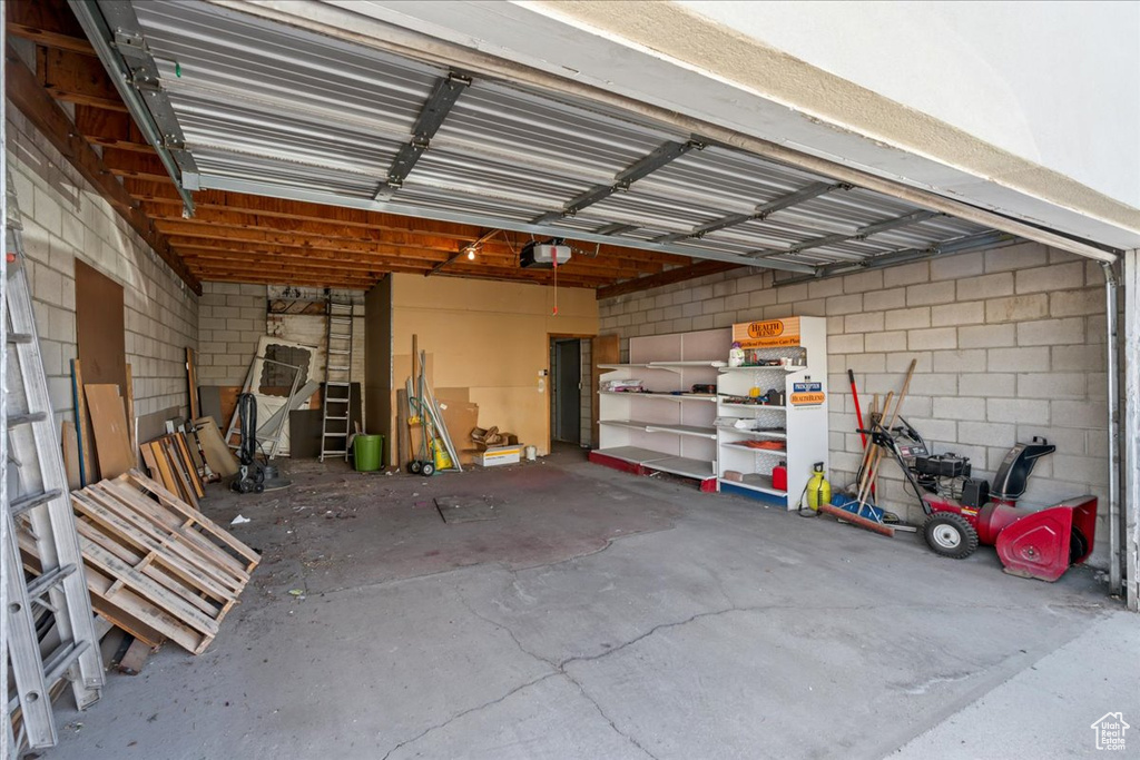 Garage with a garage door opener and concrete block wall