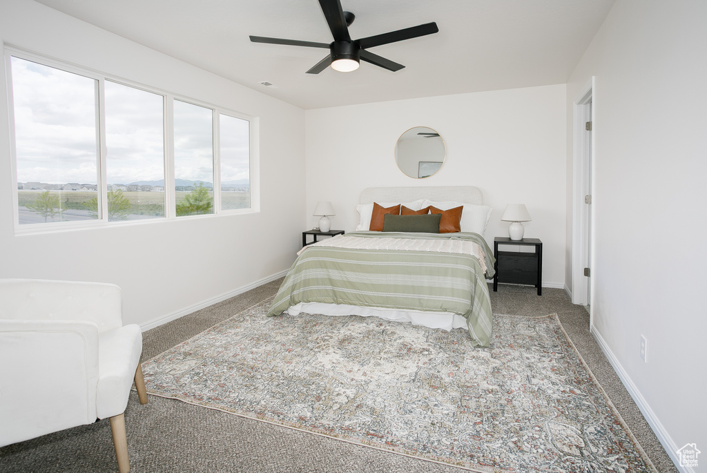 Carpeted bedroom with baseboards, a water view, and ceiling fan