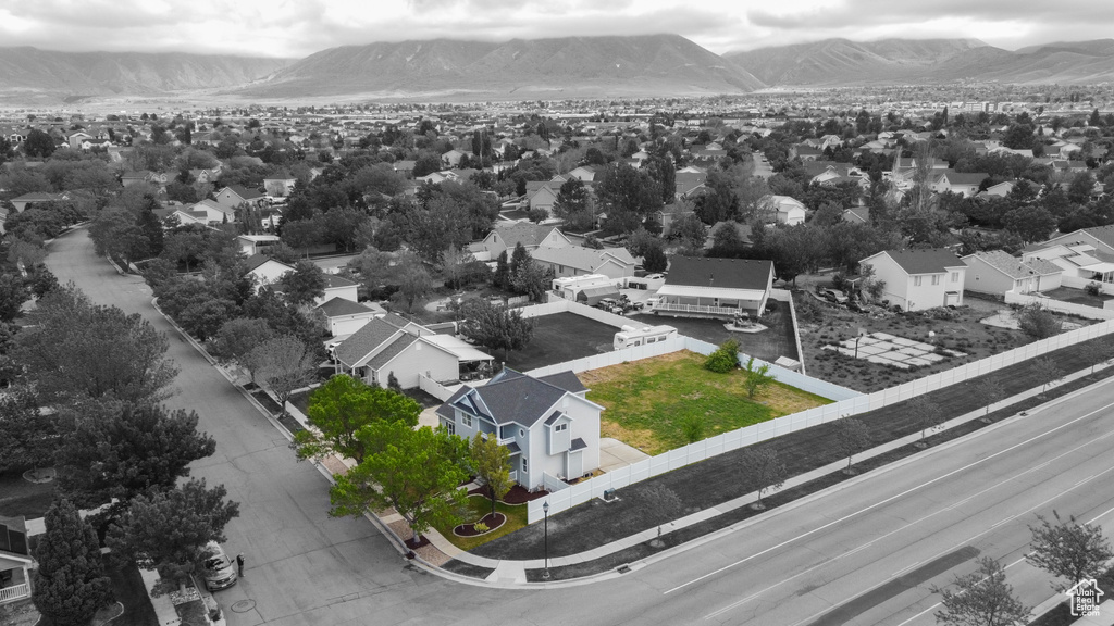 Aerial view of residential area featuring mountains and property parcel outlined