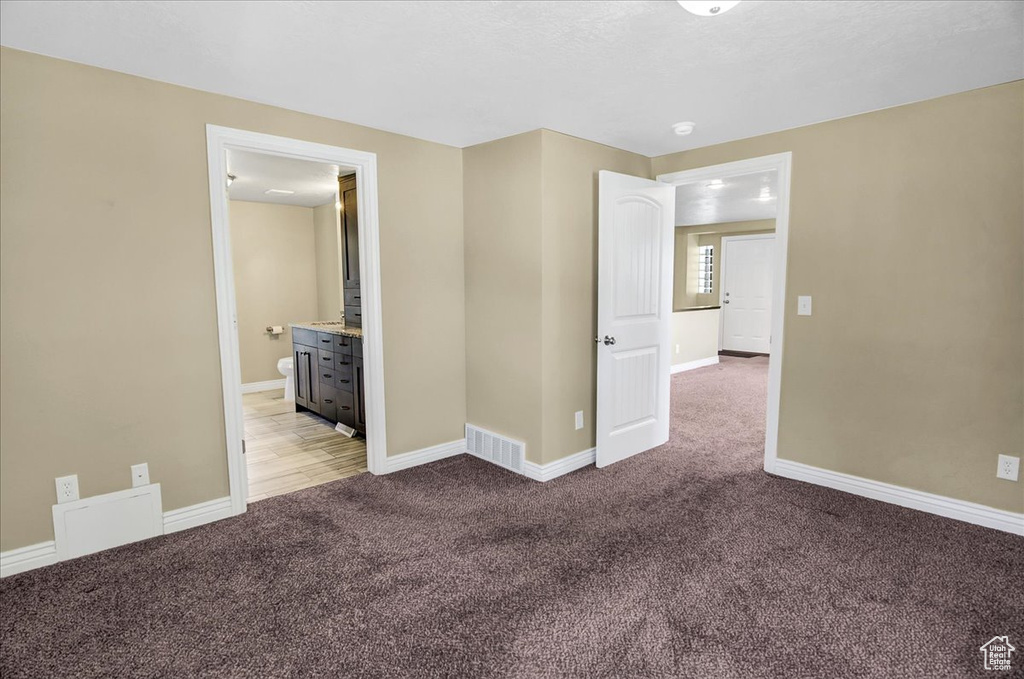 Empty room with light carpet and baseboards