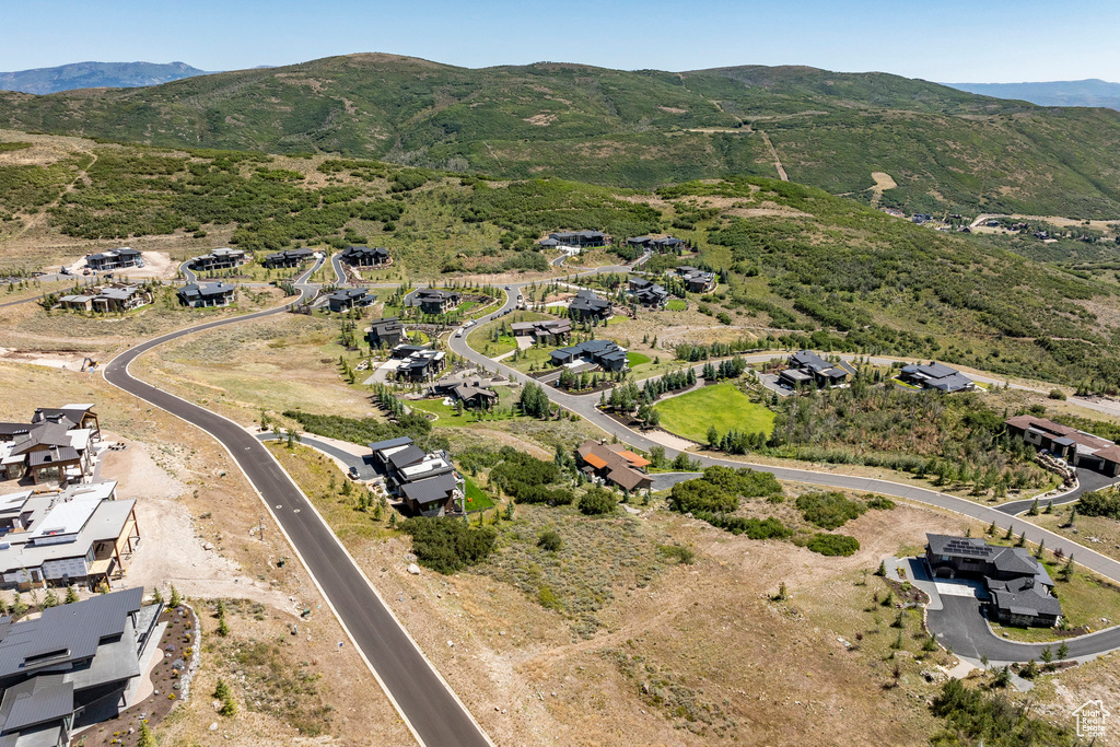 Aerial view of property's location with a mountain backdrop