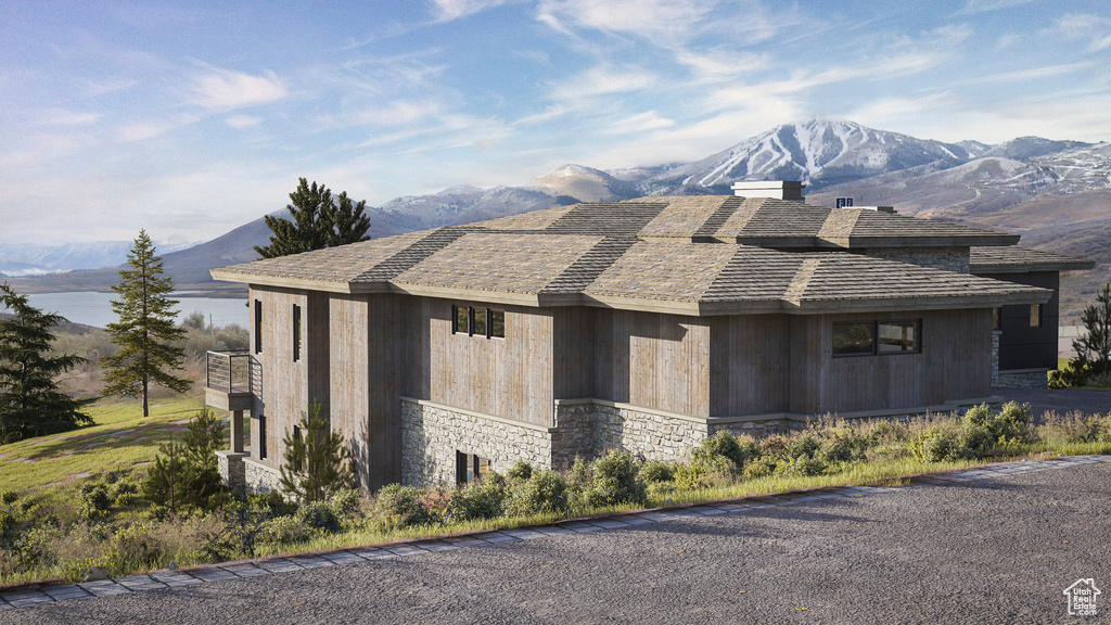 View of property exterior featuring a mountain view and stone siding