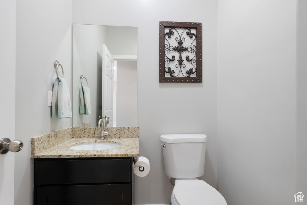 Half bathroom with toilet and vanity