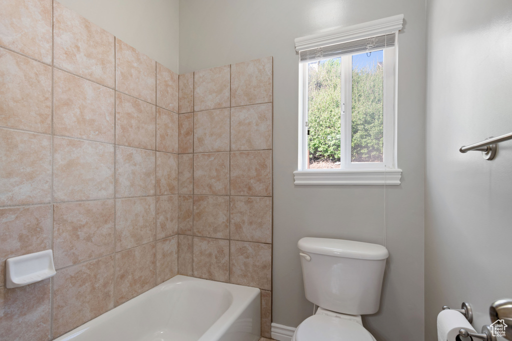 Full bath featuring toilet and shower / tub combination