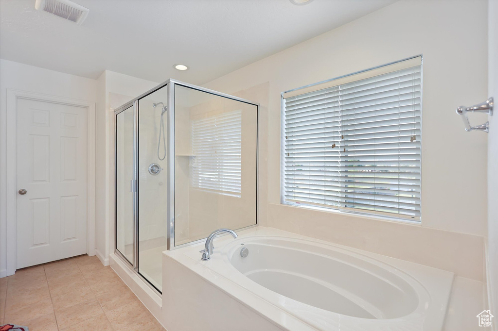 Bathroom with a stall shower, a garden tub, tile patterned floors, and recessed lighting