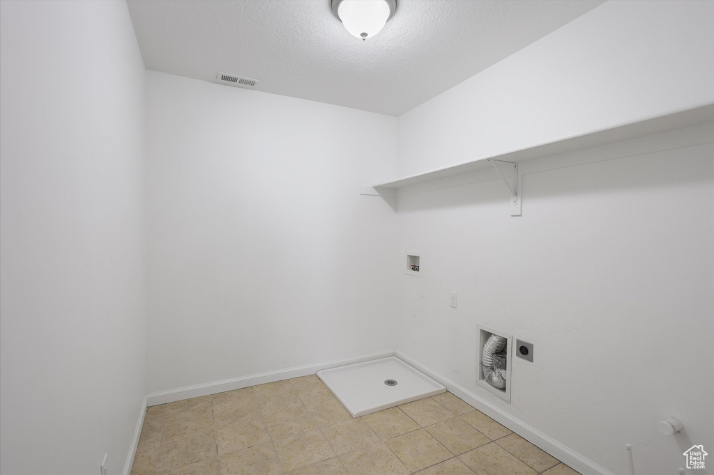 Washroom with hookup for a washing machine, hookup for a gas dryer, baseboards, and electric dryer hookup