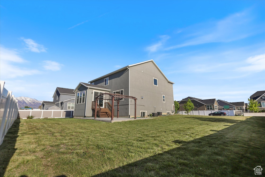 Back of property featuring a residential view and a patio
