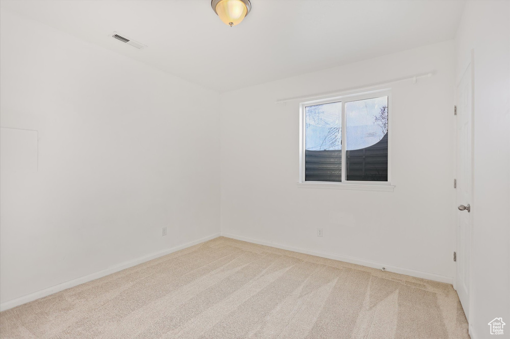 Carpeted spare room with baseboards