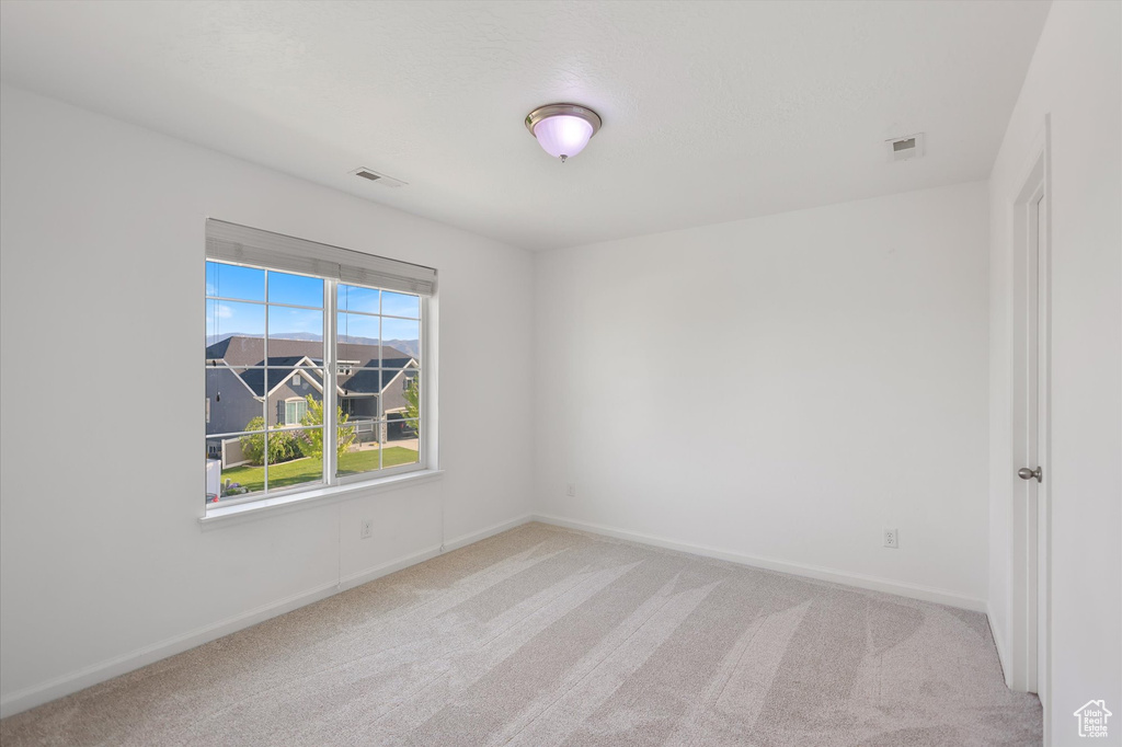 Spare room with carpet floors and baseboards