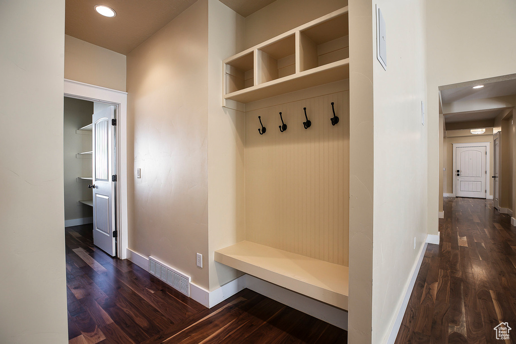 Mudroom featuring dark wood-style flooring, baseboards, and recessed lighting