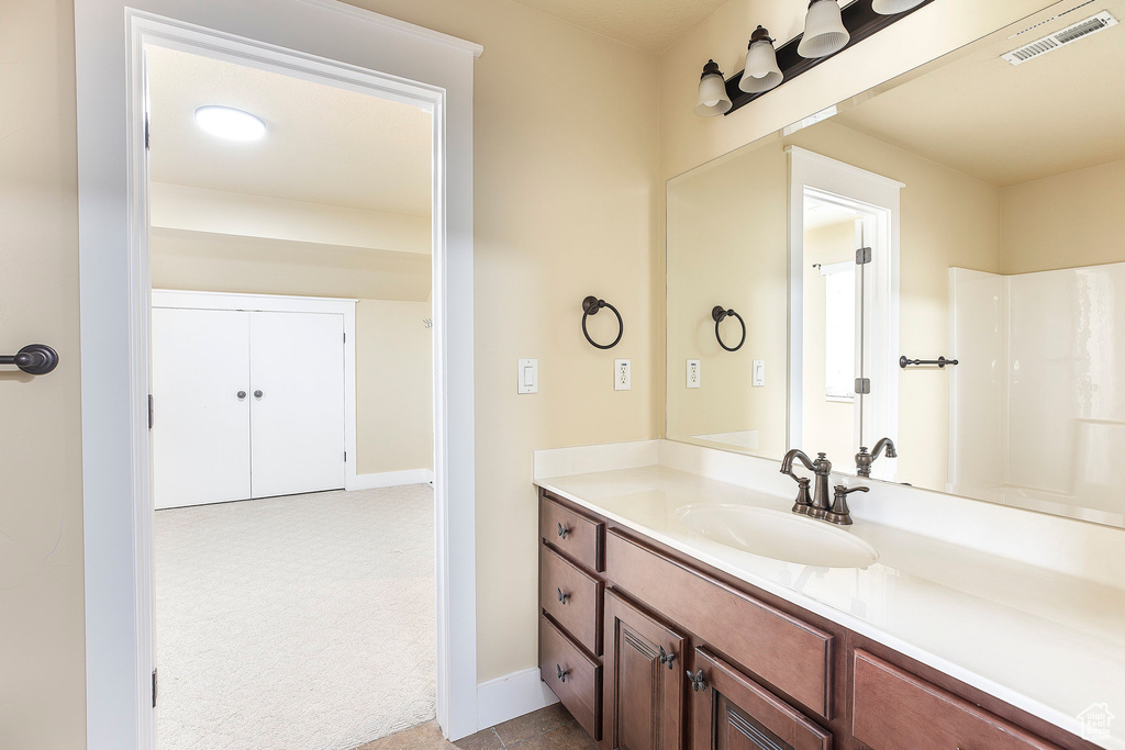 Bathroom featuring vanity and baseboards