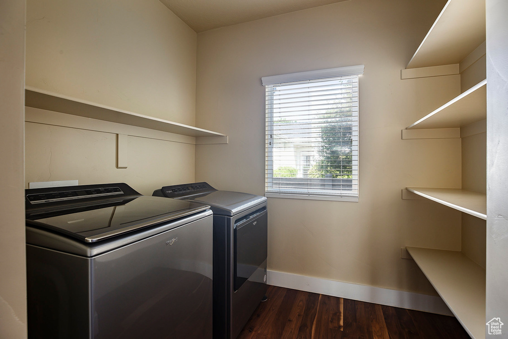 Laundry area with washer and dryer, baseboards, and dark wood-style flooring