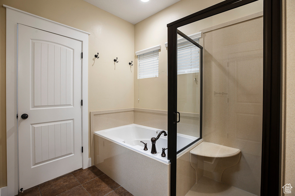 Bathroom featuring a shower stall and a garden tub