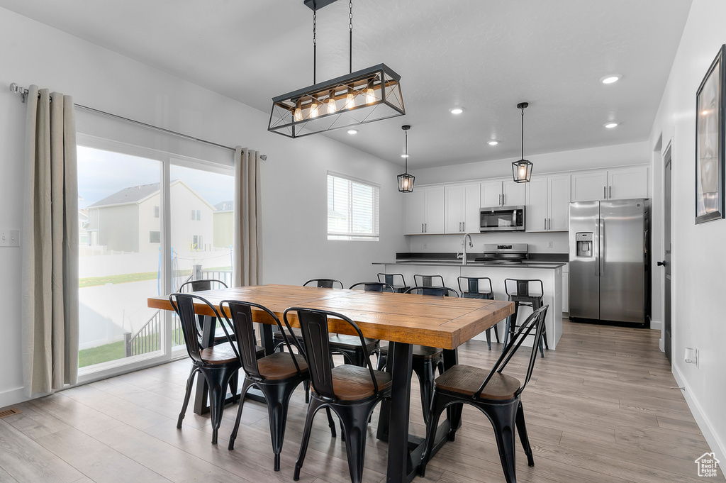 Dining room featuring recessed lighting, light wood-style flooring, and baseboards