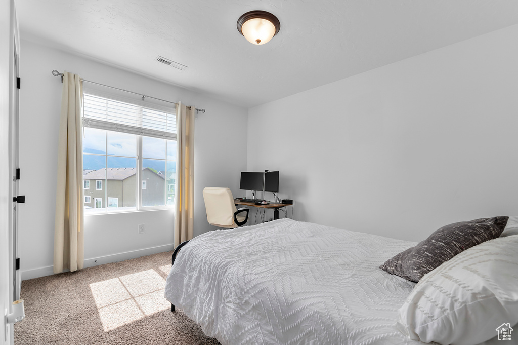 Carpeted bedroom with baseboards