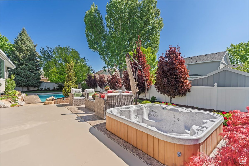 View of patio / terrace with a hot tub and a fenced backyard