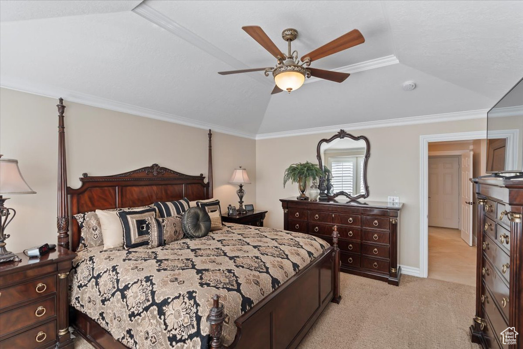 Bedroom featuring light carpet, ornamental molding, a ceiling fan, and vaulted ceiling
