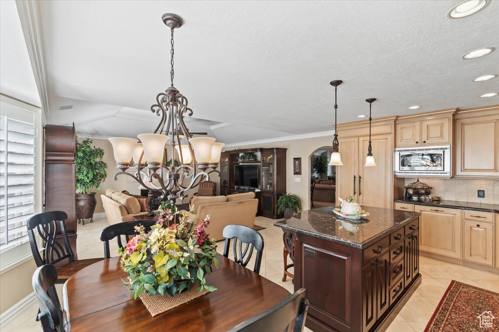 Dining area featuring a chandelier, recessed lighting, light tile patterned floors, and a textured ceiling