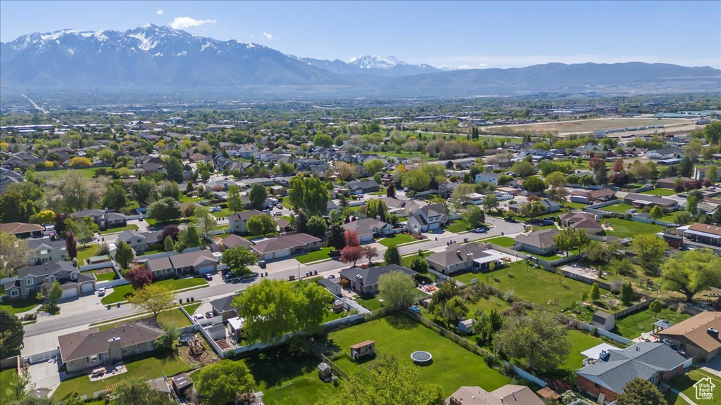 Aerial view of property's location featuring a mountainous background and nearby suburban area