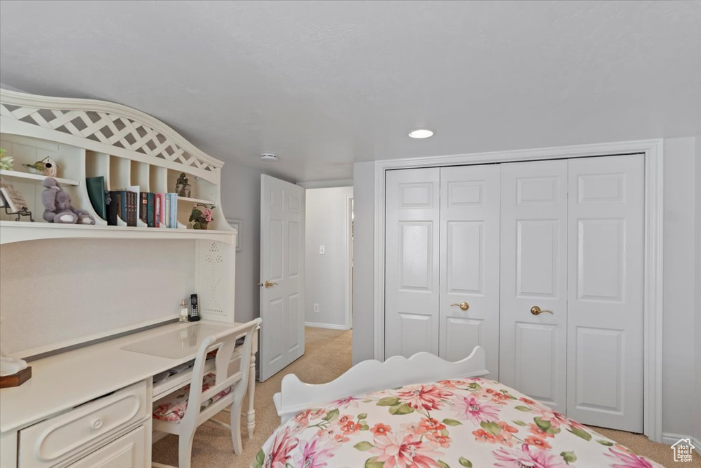 Bedroom featuring a closet, light colored carpet, and recessed lighting