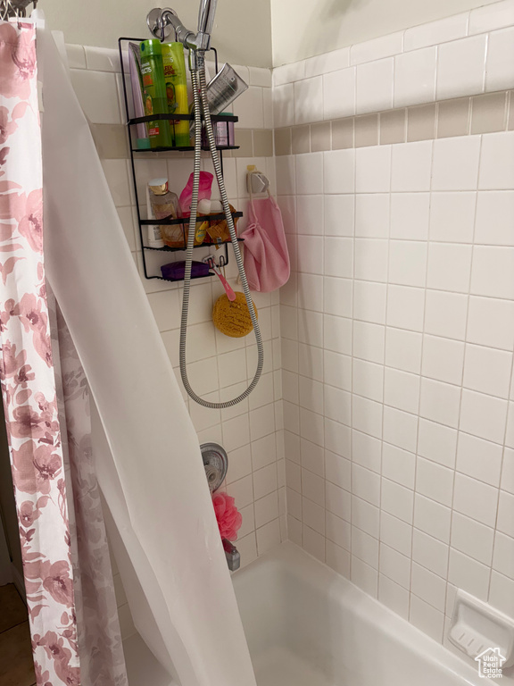 Bathroom featuring shower / bath combo with shower curtain