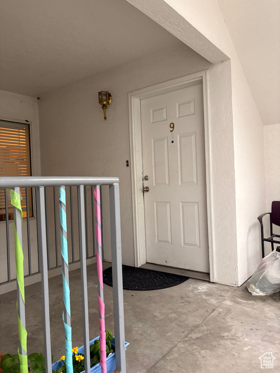 Doorway to property featuring stucco siding