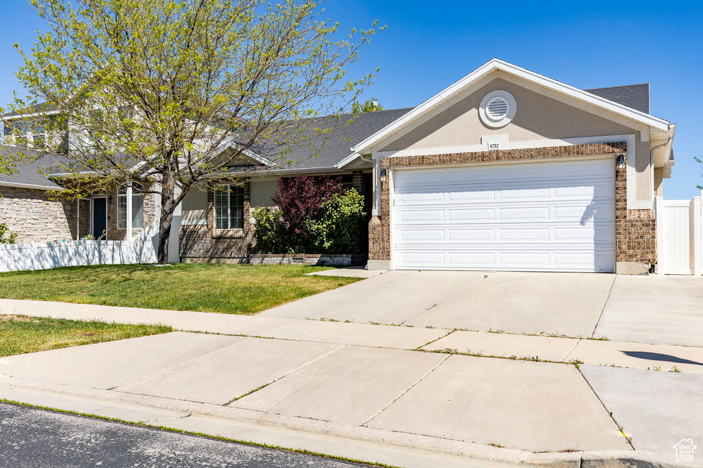View of front of home featuring brick siding, a garage, and concrete driveway