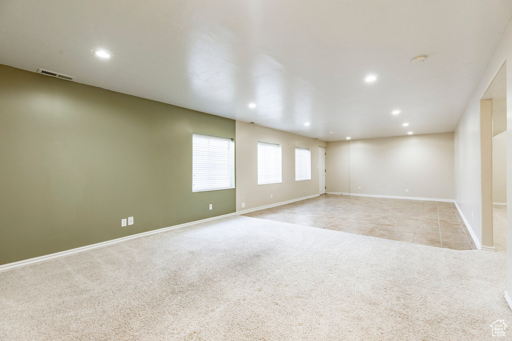 Spare room with light carpet, recessed lighting, baseboards, and a smoke detector