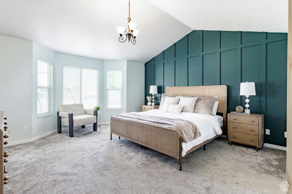 Bedroom with a chandelier, multiple windows, light carpet, lofted ceiling, and baseboards