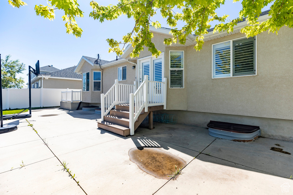 Back of house featuring fence, a patio, and stucco siding
