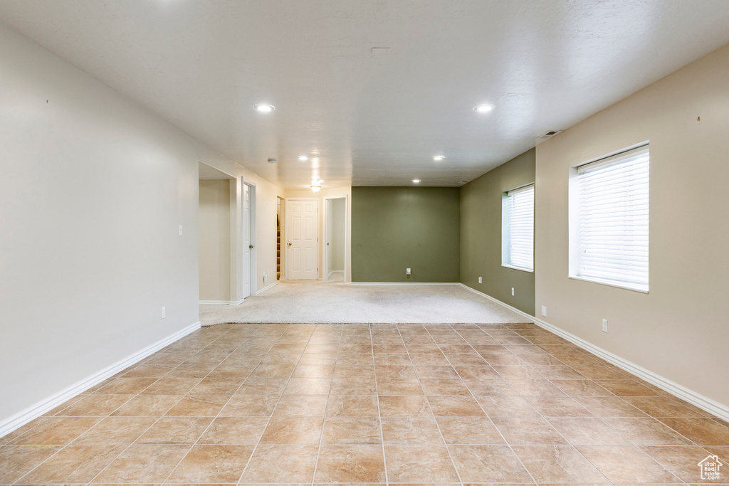 Unfurnished room featuring recessed lighting, light tile patterned floors, and baseboards