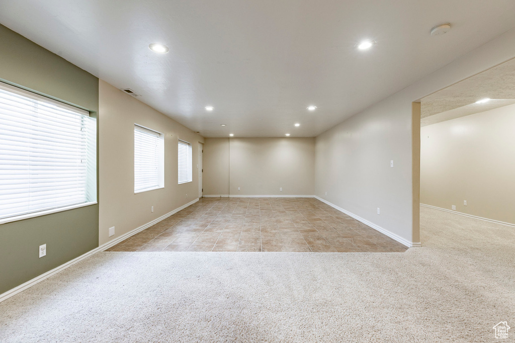Spare room with recessed lighting, light colored carpet, baseboards, and a smoke detector