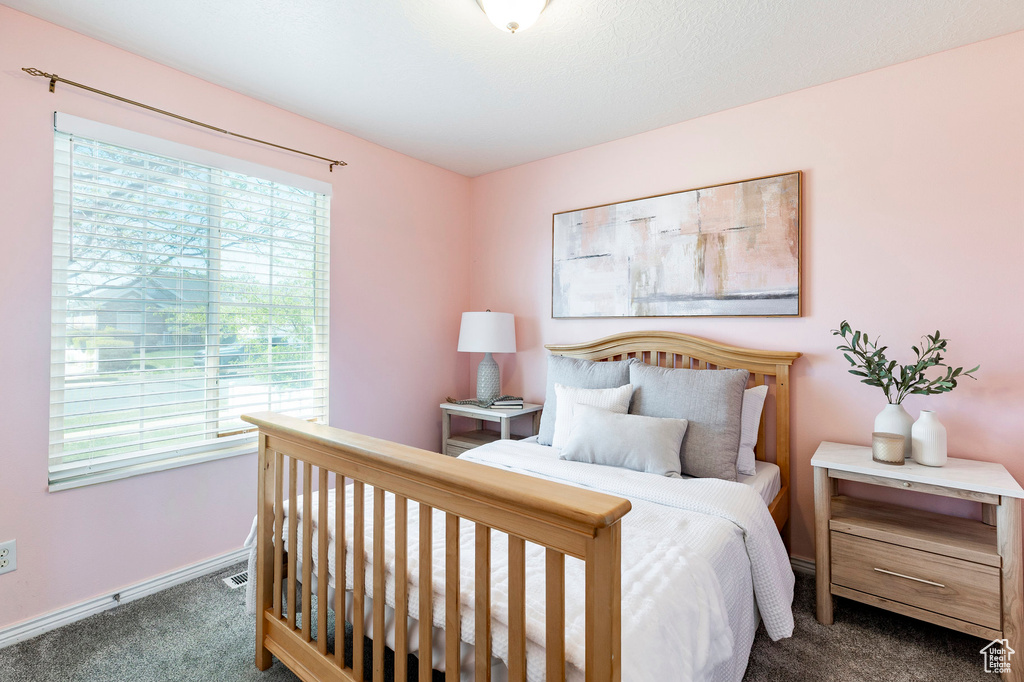 Bedroom featuring carpet floors and baseboards