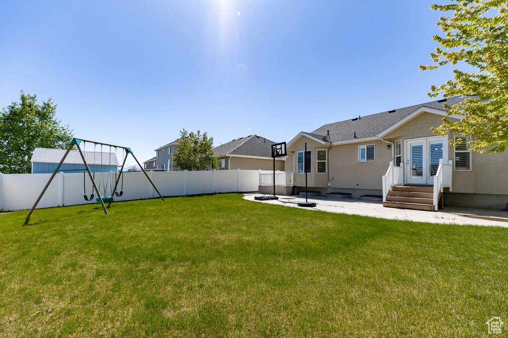 View of yard featuring a patio, a playground, and entry steps