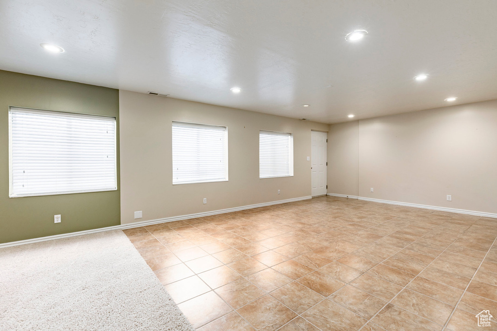 Unfurnished room featuring recessed lighting, light tile patterned floors, and baseboards