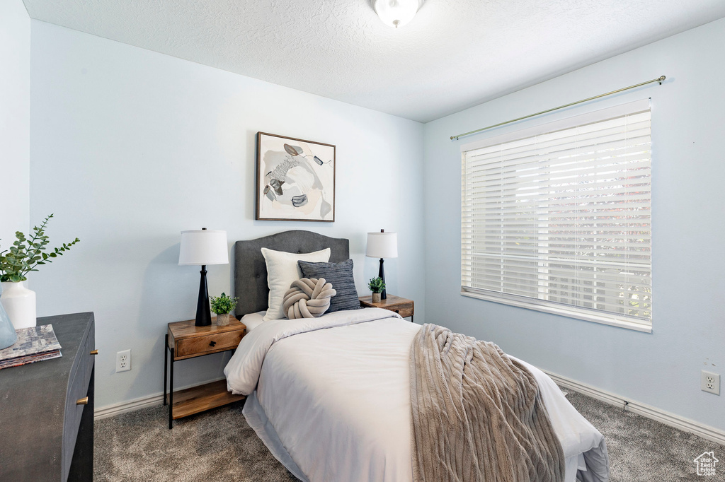 Carpeted bedroom with baseboards