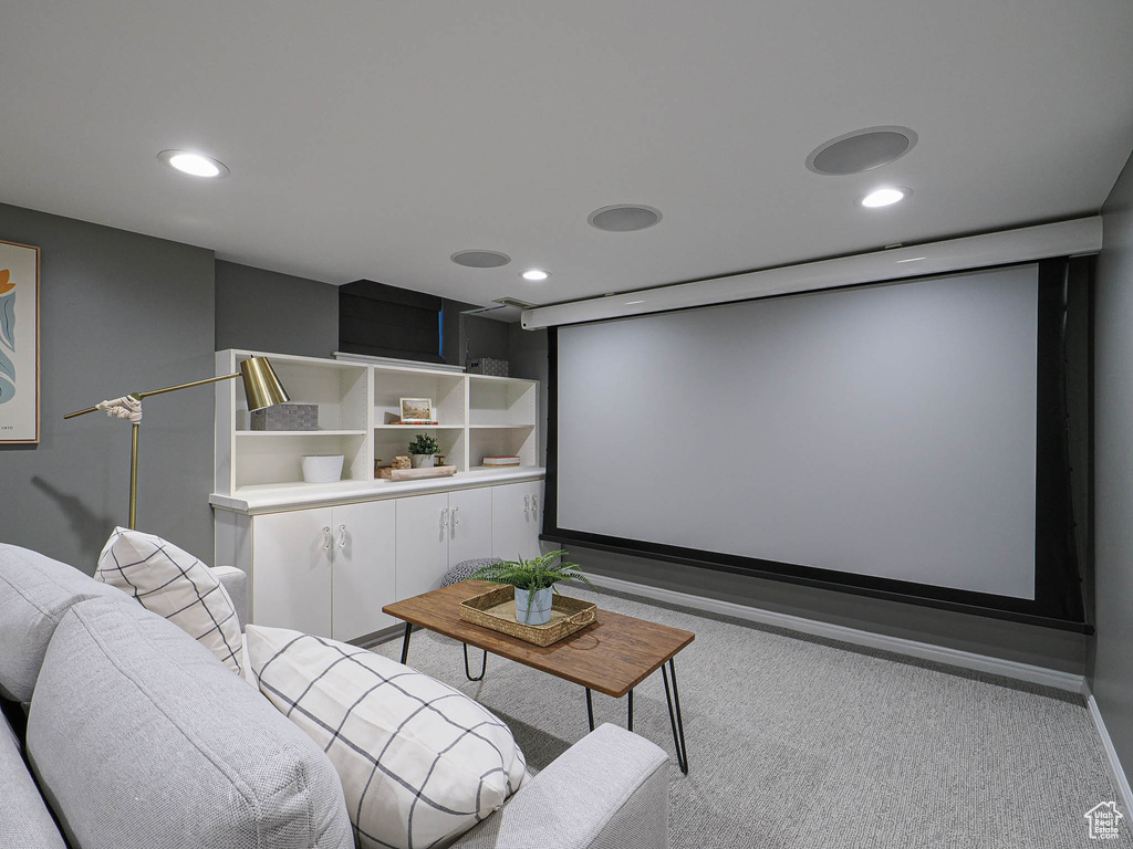 Carpeted home theater with recessed lighting and baseboards