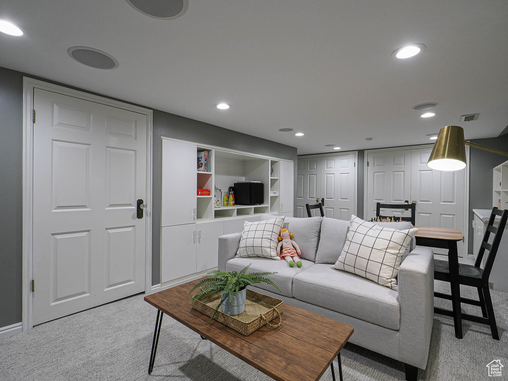 Living room featuring light carpet, recessed lighting, and baseboards