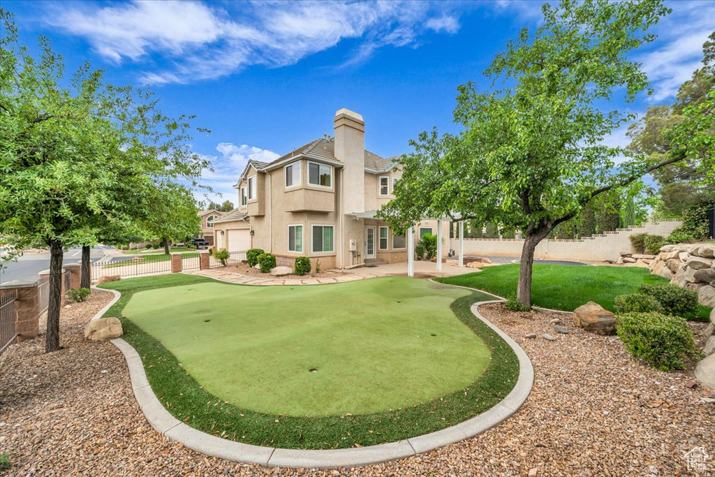 View of home\\\\\\\'s community featuring a putting area, fence, a patio area, and a pergola