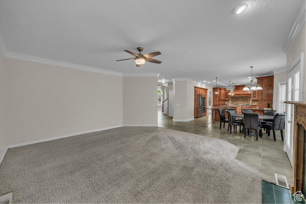 Living area with baseboards, a ceiling fan, ornamental molding, recessed lighting, and a fireplace
