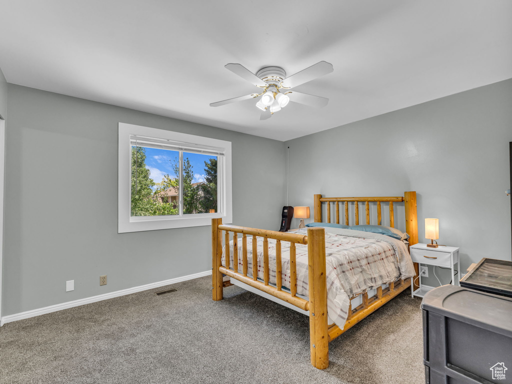 Bedroom featuring baseboards, carpet floors, and a ceiling fan