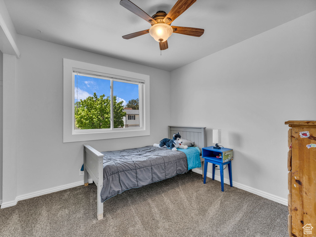 Bedroom featuring carpet flooring, baseboards, and ceiling fan