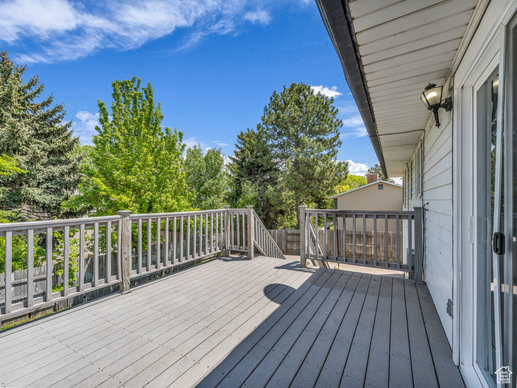 Wooden deck featuring view of wooded area