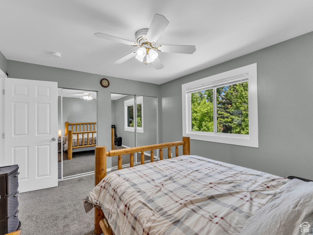 Bedroom with carpet floors, a closet, and a ceiling fan