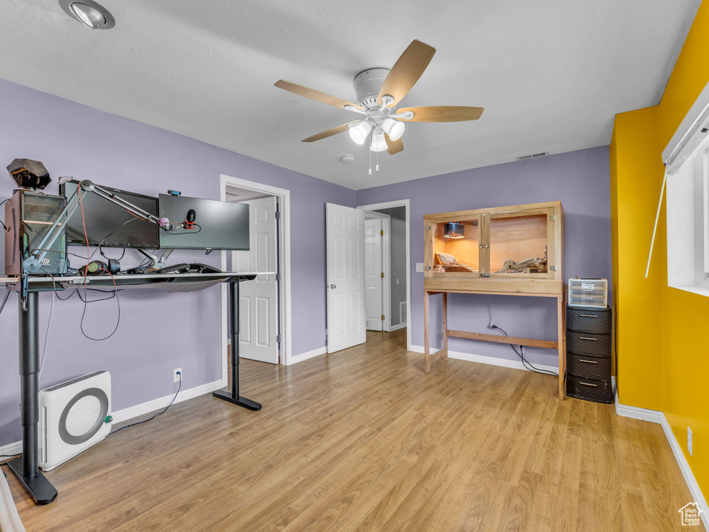 Bedroom with baseboards, light wood-style flooring, and ceiling fan