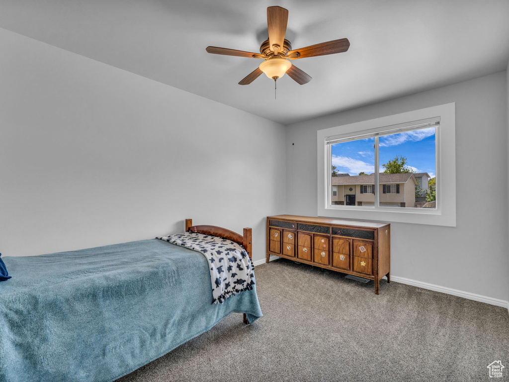 Bedroom with baseboards, carpet floors, and ceiling fan