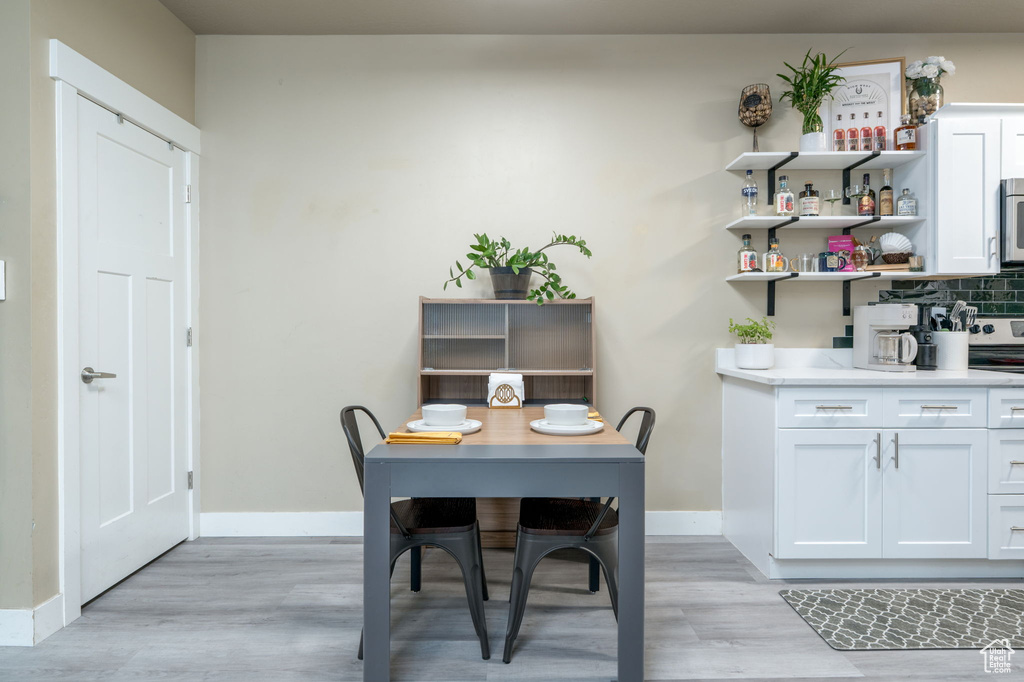 Dining room with light wood-style floors and baseboards