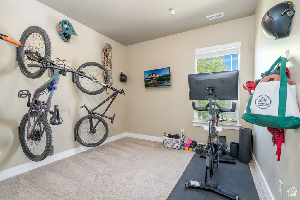 Workout area featuring carpet and baseboards