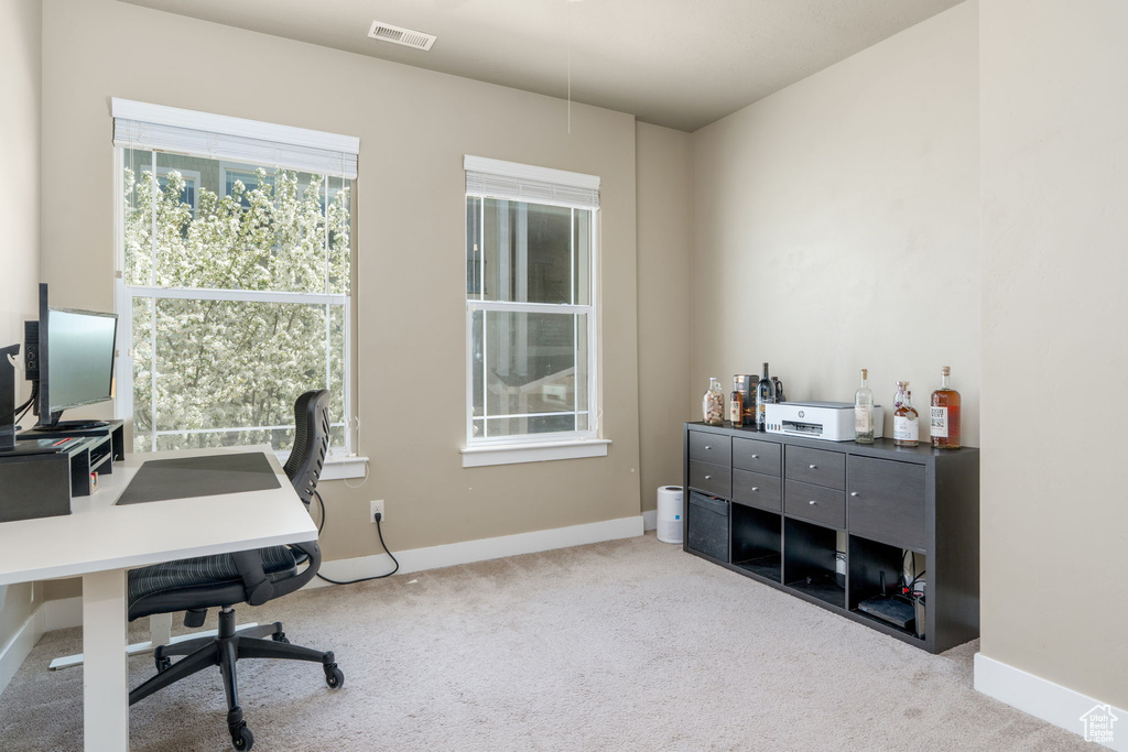 Home office featuring carpet and baseboards